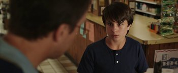 Movie still from “Labor Day” (2013), directed by Jason Reitman – A young boy looking at a younger man in a kitchen; Close Up shot, Over the shoulder angle
