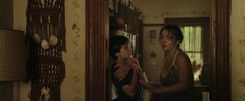Movie still from “Labor Day” (2013), directed by Jason Reitman – A woman and a child in a kitchen; Medium shot, Over the shoulder angle