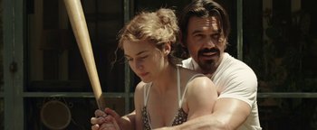 Movie still from “Labor Day” (2013), directed by Jason Reitman – A man and a woman holding a baseball bat; Medium shot, Over the shoulder angle