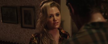Movie still from “Labor Day” (2013), directed by Jason Reitman – A beautiful young lady wearing a floral shirt; Close Up shot, Over the shoulder angle