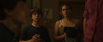 Movie still from “Labor Day” (2013), directed by Jason Reitman – A woman and a young boy standing next to each other in a room; Medium shot, Over the shoulder angle