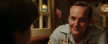 Movie still from “Labor Day” (2013), directed by Jason Reitman – A person sitting in front of a window; Close Up shot, Over the shoulder angle