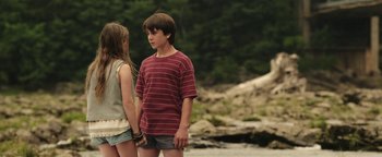 Movie still from “Labor Day” (2013), directed by Jason Reitman – A boy and a girl standing next to each other on a beach; Medium shot, Over the shoulder angle