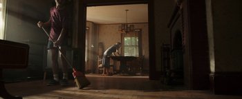 Movie still from “Labor Day” (2013), directed by Jason Reitman – A woman standing in front of a table in a living room; Wide shot, Low angle