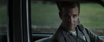 Movie still from “Labor Day” (2013), directed by Jason Reitman – A man sitting in the back seat of a car; Close Up shot, Over the shoulder angle