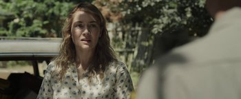 Movie still from “Labor Day” (2013), directed by Jason Reitman – A woman in a white shirt is standing in front of a tree; Close Up shot, Over the shoulder angle