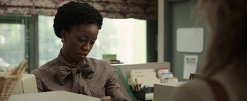 Movie still from “Labor Day” (2013), directed by Jason Reitman – A woman sitting at a desk looking down at papers; Close Up shot, Over the shoulder angle
