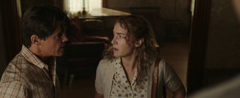 Movie still from “Labor Day” (2013), directed by Jason Reitman – A woman with a purse sitting in a living room; Close Up shot, Over the shoulder angle