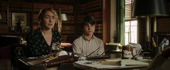 Movie still from “Labor Day” (2013), directed by Jason Reitman – Two people sitting at a table in a room; Medium shot, Over the shoulder angle