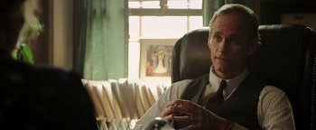 Movie still from “Labor Day” (2013), directed by Jason Reitman – A man sitting in an office chair in front of a window; Close Up shot, Over the shoulder angle