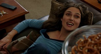 Movie still from “Laggies” (2014), directed by Lynn Shelton – A beautiful young lady laying on a couch; Close Up shot, Over the shoulder angle