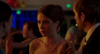 Movie still from “Laggies” (2014), directed by Lynn Shelton – A woman in a strapless dress with a pearl necklace; Close Up shot, Over the shoulder angle