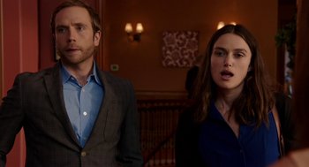 Movie still from “Laggies” (2014), directed by Lynn Shelton – A man and a woman standing next to each other in a room; Medium shot, Over the shoulder angle