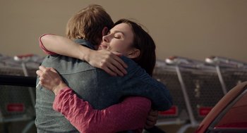 Movie still from “Laggies” (2014), directed by Lynn Shelton – A man and a woman hugging each other in a room; Close Up shot, Over the shoulder angle