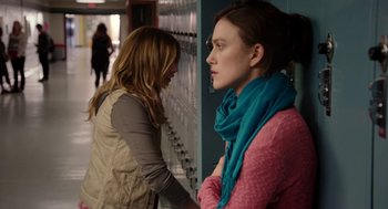 Movie still from “Laggies” (2014), directed by Lynn Shelton – Two women standing next to each other in front of lockers; Medium shot, Over the shoulder angle