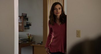 Movie still from “Laggies” (2014), directed by Lynn Shelton – A woman standing in a room with her hands in her pockets; Medium shot, Over the shoulder angle