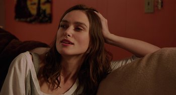 Movie still from “Laggies” (2014), directed by Lynn Shelton – A woman sitting on top of a couch with her hand in her hair; Close Up shot, Over the shoulder angle