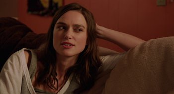 Movie still from “Laggies” (2014), directed by Lynn Shelton – A woman sitting on a couch with her hand behind her head; Close Up shot, Over the shoulder angle