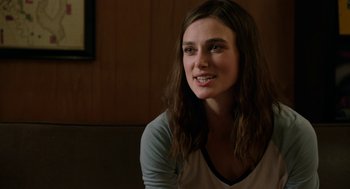 Movie still from “Laggies” (2014), directed by Lynn Shelton – A woman with long brown hair sitting in a room; Close Up shot, Over the shoulder angle