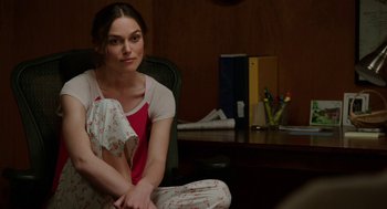 Movie still from “Laggies” (2014), directed by Lynn Shelton – A woman sitting on a chair in a room; Medium shot, Over the shoulder angle