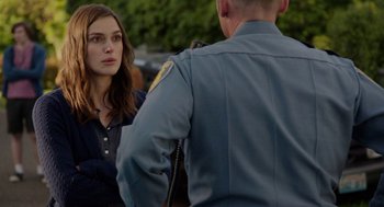 Movie still from “Laggies” (2014), directed by Lynn Shelton – A police officer talking to a woman in a parking lot; Medium shot, Over the shoulder angle
