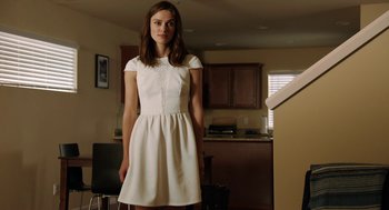 Movie still from “Laggies” (2014), directed by Lynn Shelton – A woman in a white dress standing in a kitchen; Medium shot, Low angle
