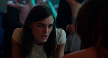 Movie still from “Laggies” (2014), directed by Lynn Shelton – A woman in a white dress sitting in front of a crowd; Close Up shot, Over the shoulder angle