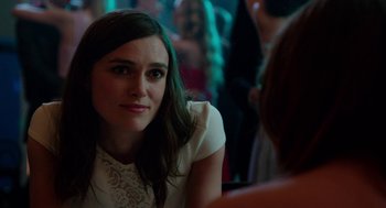 Movie still from “Laggies” (2014), directed by Lynn Shelton – A woman sitting in front of a crowd of people at a party; Close Up shot, Over the shoulder angle