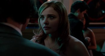 Movie still from “Laggies” (2014), directed by Lynn Shelton – A woman is looking into the distance while sitting at a table; Close Up shot, Over the shoulder angle