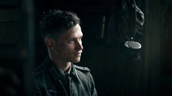 Movie still from “Land of Mine” (2015), directed by Martin Zandvliet – A man in a military uniform looking to his left; Close Up shot, Over the shoulder angle