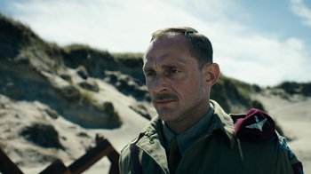 Movie still from “Land of Mine” (2015), directed by Martin Zandvliet – A person wearing a military uniform; Close Up shot, Low angle
