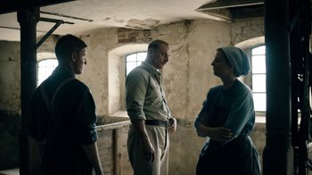 Movie still from “Land of Mine” (2015), directed by Martin Zandvliet – A group of people standing in an old building; Medium shot, Over the shoulder angle