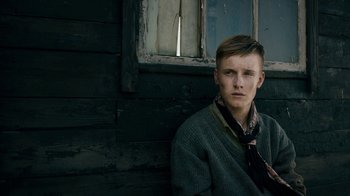 Movie still from “Land of Mine” (2015), directed by Martin Zandvliet – A young man sitting in front of a window; Close Up shot, Low angle
