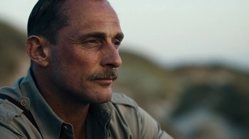 Movie still from “Land of Mine” (2015), directed by Martin Zandvliet – A person with a mustache; Close Up shot, Over the shoulder angle