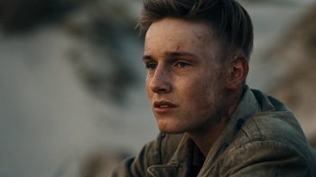 Movie still from “Land of Mine” (2015), directed by Martin Zandvliet – A young man is looking into the distance; Close Up shot, Over the shoulder angle