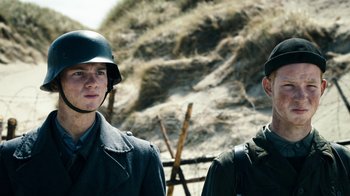 Movie still from “Land of Mine” (2015), directed by Martin Zandvliet – Two men in military uniforms standing next to each other; Close Up shot, Low angle