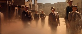 Movie still from “Last Man Standing” (1996), directed by Walter Hill – A group of men walking down a street in the fog; Wide shot, Low angle