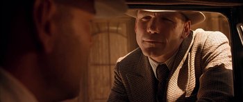 Movie still from “Last Man Standing” (1996), directed by Walter Hill – A man wearing a suit and a hat looking at another man in a hat; Close Up shot, Over the shoulder angle