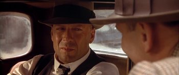 Movie still from “Last Man Standing” (1996), directed by Walter Hill – A person wearing a hat; Close Up shot, Over the shoulder angle