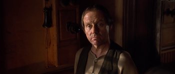Movie still from “Last Man Standing” (1996), directed by Walter Hill – A man in a vest and tie looking at the camera; Close Up shot, Low angle