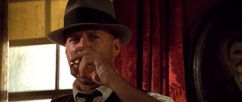 Movie still from “Last Man Standing” (1996), directed by Walter Hill – A man wearing a hat drinking a glass of wine; Close Up shot, Low angle