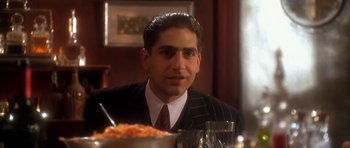 Movie still from “Last Man Standing” (1996), directed by Walter Hill – A person sitting in front of a plate of food; Close Up shot, Low angle