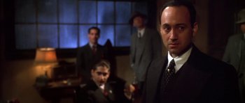 Movie still from “Last Man Standing” (1996), directed by Walter Hill – A group of men in suits and ties standing next to each other in a room; Medium shot, Low angle