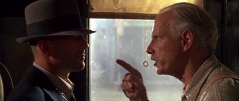 Movie still from “Last Man Standing” (1996), directed by Walter Hill – A man in a hat and a man in a hat talking to each other; Close Up shot, Over the shoulder angle