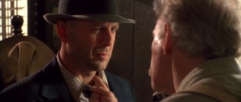Movie still from “Last Man Standing” (1996), directed by Walter Hill – A man wearing a hat and a tie looking at himself in the mirror; Close Up shot, Over the shoulder angle
