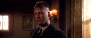 Movie still from “Last Man Standing” (1996), directed by Walter Hill – A person wearing a suit and tie; Close Up shot, Low angle