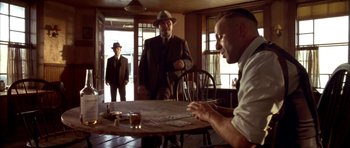 Movie still from “Last Man Standing” (1996), directed by Walter Hill – A group of men sitting at a table playing a game; Medium shot, Over the shoulder angle