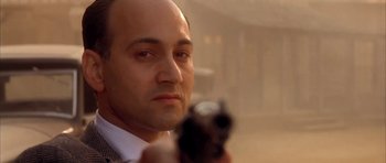 Movie still from “Last Man Standing” (1996), directed by Walter Hill – A person holding a gun; Close Up shot, Low angle