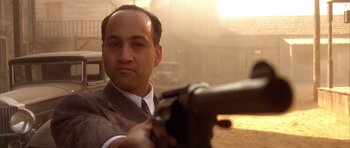Movie still from “Last Man Standing” (1996), directed by Walter Hill – A man in a suit and tie holding a gun; Close Up shot, Over the shoulder angle