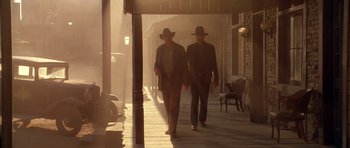 Movie still from “Last Man Standing” (1996), directed by Walter Hill – A couple of men walking down a street in the fog; Wide shot, Low angle